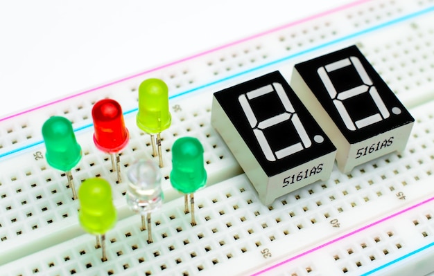 7-segment arduino indicators attached to a breadboard with a colorful diodes. Concept of a technical