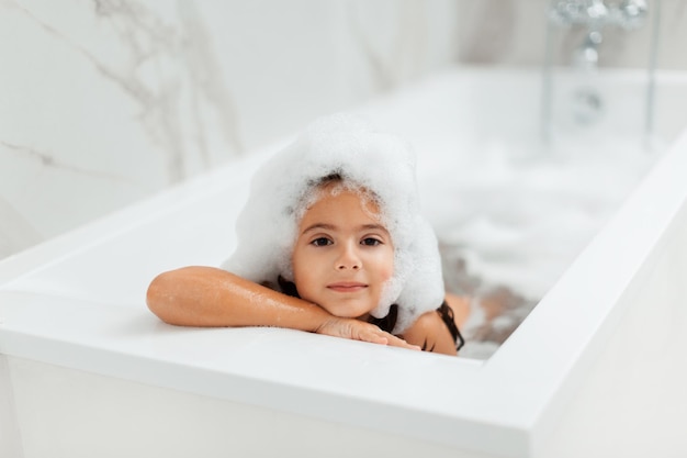 7 years girl taking  bubble bath