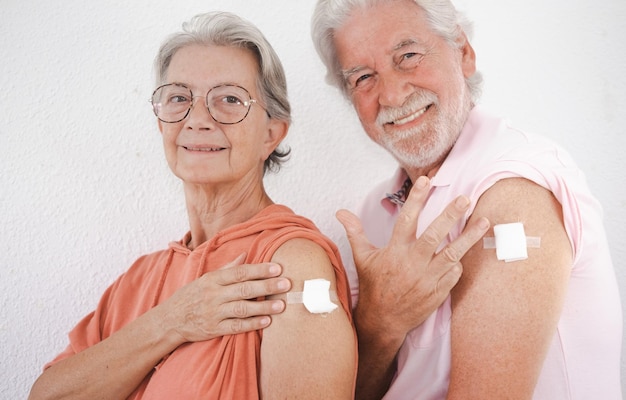 70yearold Caucasian couple after receiving the fourth booster dose of the covid19 coronavirus vaccine Concept of protection responsibility and healthcare