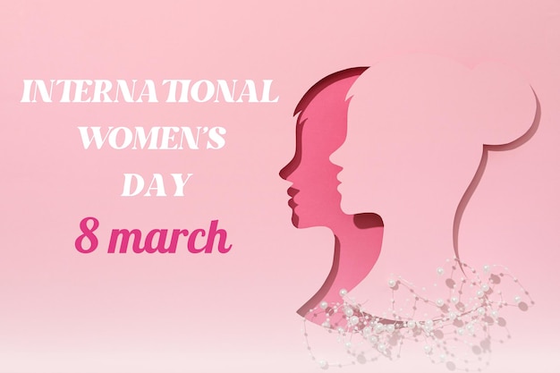 8 march international womens day paper cut out womans face in profile and white beads on a pink background with text