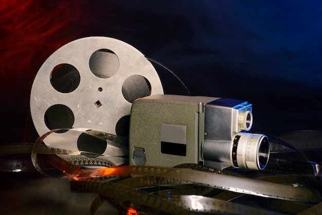 8 mm movie camera with a reel of film in blue and red smoke