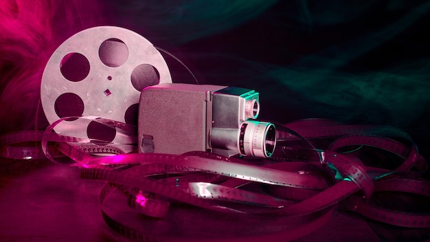 8 mm movie camera with a reel of film in green and purple smoke