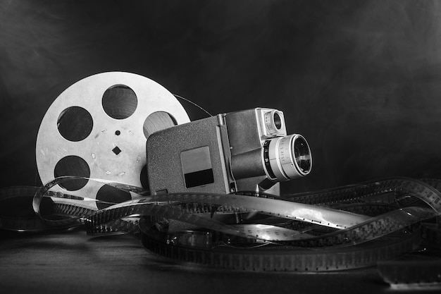 8 mm movie camera with a reel of film in smoke black and
white