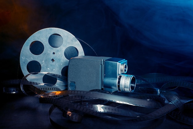 8 mm movie camera with a reel of film in smoke