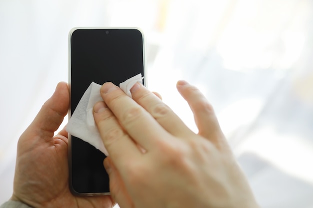 ÃÂÃÂÃÂÃÂ¡leaning concept. Wipe dirt off surfaces. Disinfectant treatment of phone screenl. Sanitary treatment at home in quarantine.