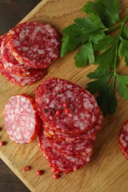 ÃÂ¡oncept of tasty food with salami sausage on wooden background