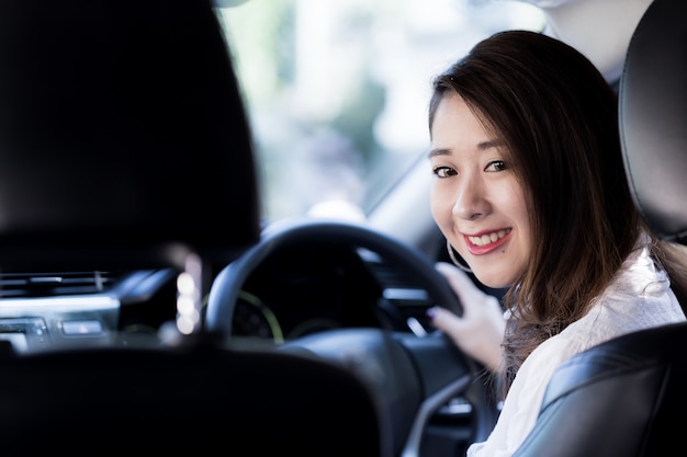 写真 良い気分で美しい若い女性が車で旅行しています。