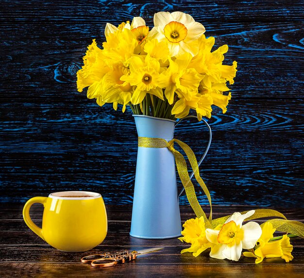 写真 青い花瓶に花束の花束黄色いカップのコーヒーヴィンテージの剪刀