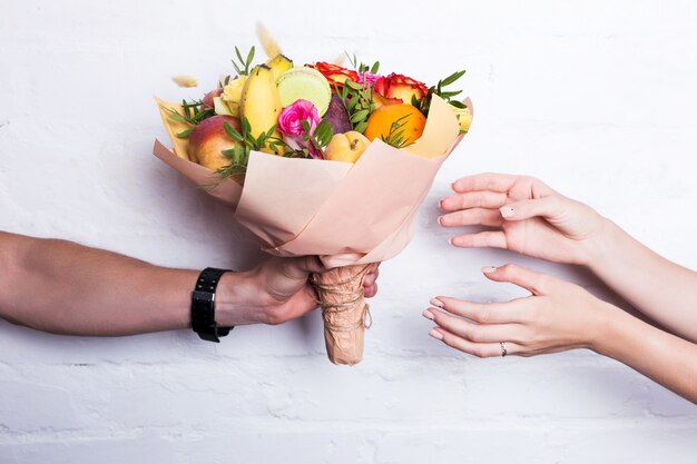 果物と花の花束は男性から贈られます