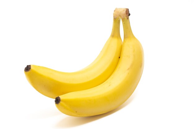 写真 白い背景に隔離された2つの新鮮な有機バナナと美味しい果物のサイドビューの束