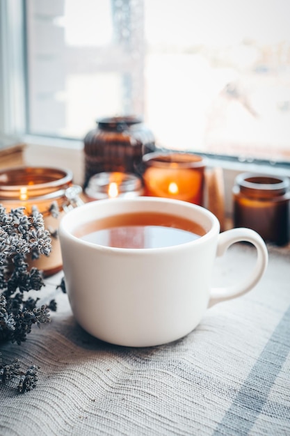 Фото Чашка травяного чая с горящими свечами эстетично теплое фото