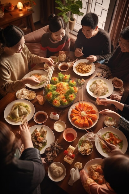 사진 전통적 인 중국 신년 축제 를 즐기고 있는 한 가족 이 테이블 을 둘러싸고 모여