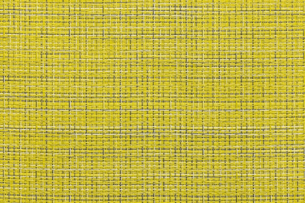 Фото Фрагмент соломенного коврика, как фон или текстура, желтый и серый цвет, крупный план.