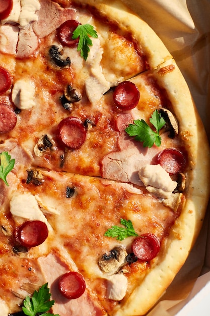 사진 얇게 썬 토마토 치즈 버섯과 허브를 곁들인 갓 구운 피자에는 야외 피크닉에서 함께 식사할 것을 암시하는 두 조각이 없습니다.