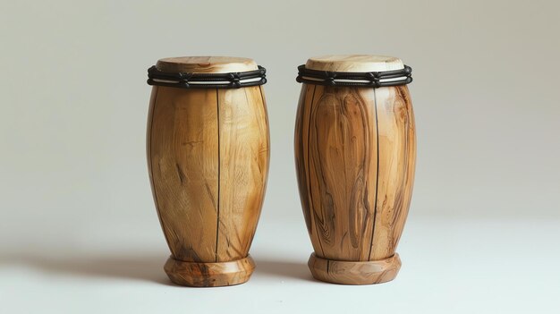 Foto a pair of wooden bongos with natural skin heads and black rope tuning the bongos are sitting on a white surface with a white background