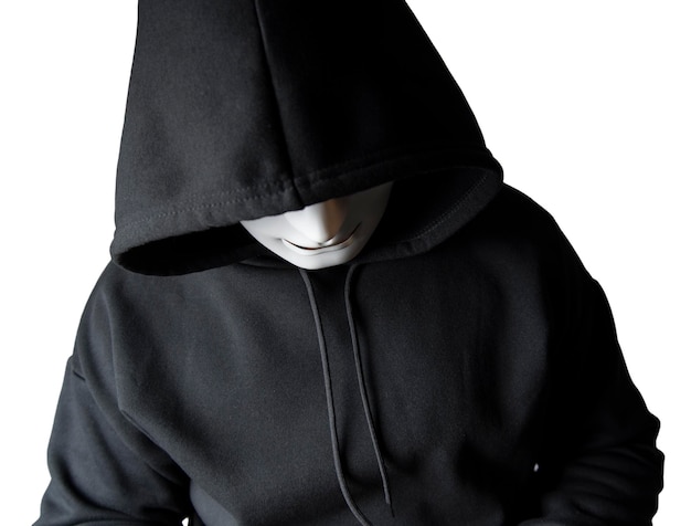 写真 マスクを着用した匿名のハッカーのポートレートと、頭を傾けて座っている黒いパーカーを着て、クリッピングパスで恐ろしいハッキングとマルウェアのコンセプト