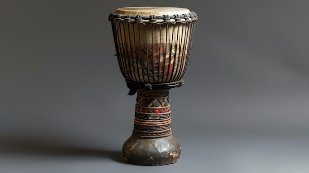 写真 a studio shot of an african djembe drum with a natural goatskin head and handcarved wooden base