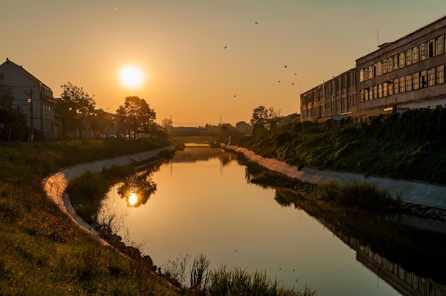 写真 早朝のベガ川の眺め。街の日の出。革と手袋の工場。