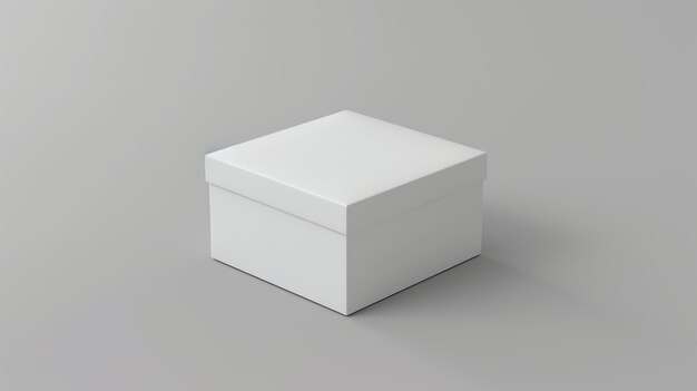 Фото Белая коробка сидит на твердом сером фоне коробка закрыта и имеет отдельную крышку коробка простая и не имеет маркировки или украшений