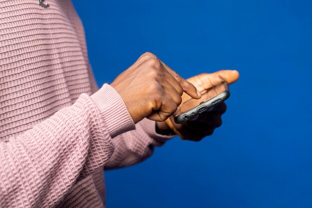 写真 スマートフォンを使ってコミュニケーションをとりゲームをプレイしソーシャルネットワークと接続している若い男性