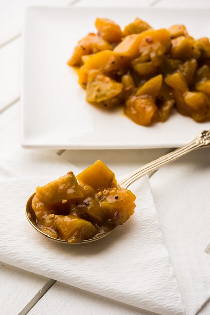 Photo aam ka murabba or methamba also known as mango sweet chutney or pickle with fenugreek or methi, served in a plate or bowl, selective focus