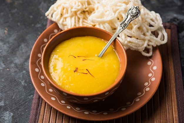 Aam Ras or Alphonso mango pulp with kurdai which is a fried dish made using wheat or gehu. selective focus