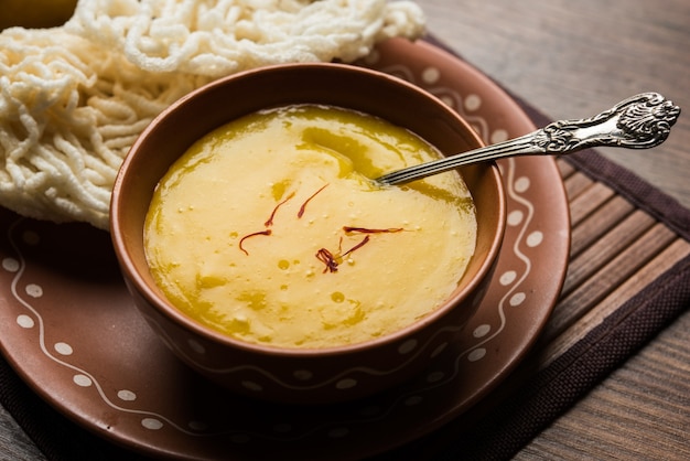 Aam Ras or Alphonso mango pulp with kurdai which is a fried dish made using wheat or gehu. selective focus