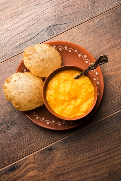 Aam Ras Puri OR Alphonso  Mango pulp with fried Poori, selective focus