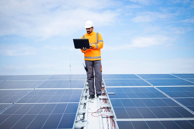 Aannemer van het zonnebedrijf controleert de functionaliteit van fotovoltaïsche zonnepanelen