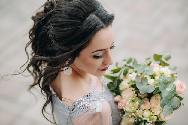 Foto aantrekkelijk bruidsmeisje met bruidsboeket meid met natuurlijke bloemen en poseren voor de camera