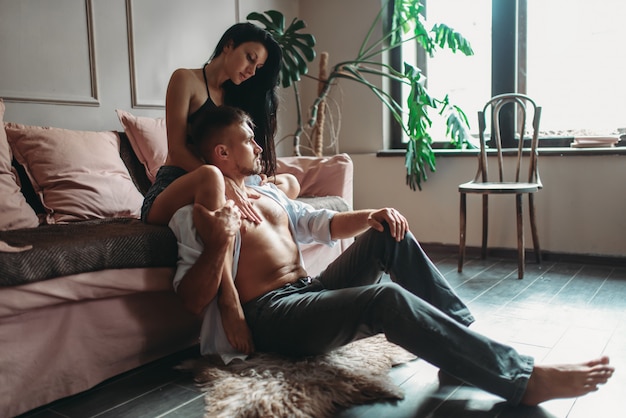 Aantrekkelijk paar knuffels op de bank, sensualiteit erotiek. Erotische scène, seksuele relatie
