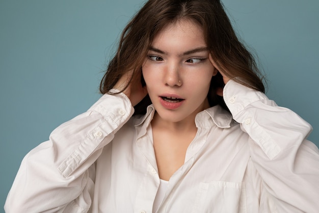 Aantrekkelijke grappige amusante vrolijke schattige aardige schattige tedere jonge krullende brunette vrouw die wit draagt