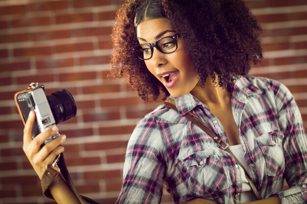 Aantrekkelijke hipster die selfies met camera neemt