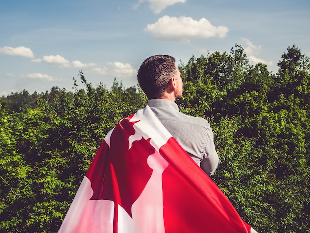 Aantrekkelijke man met Canadese vlag. nationale feestdag