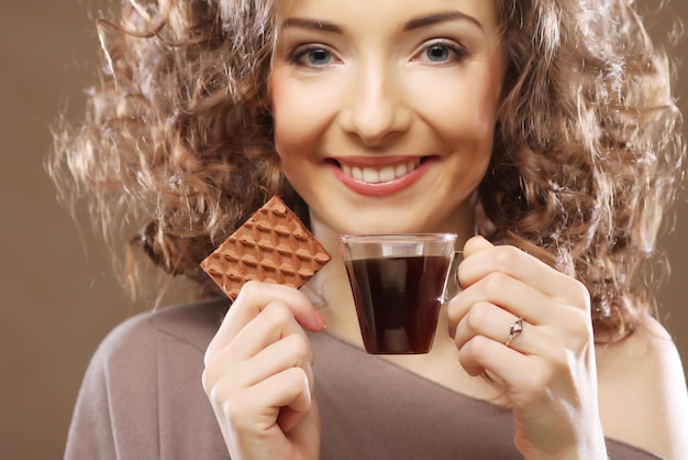 Foto aantrekkelijke vrouw met koffie en koekjes