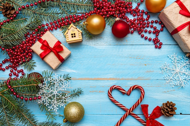 aanwezig met rode strik en kerstversiering op de blauw geschilderde houten achtergrond