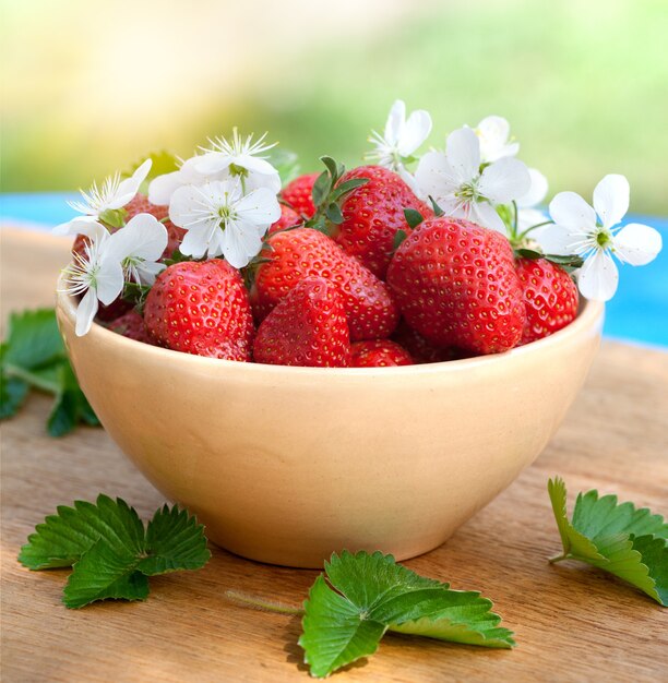 Aardbeien in een kom op een houten tafel