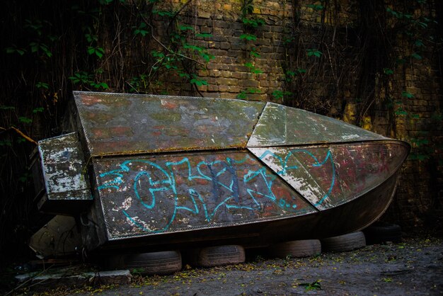 Abandoned boat against wall