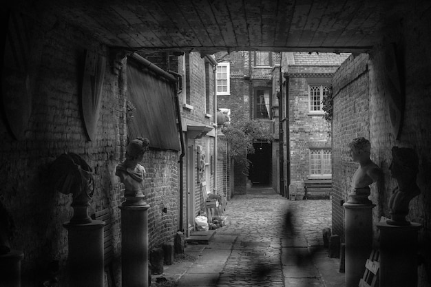 Abandoned busts in tunnel against building