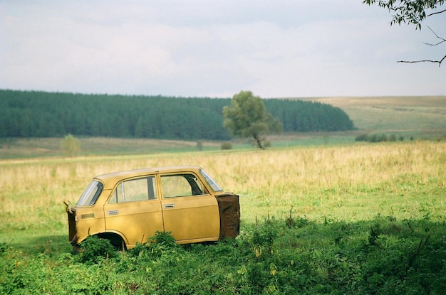 Abandoned car on field