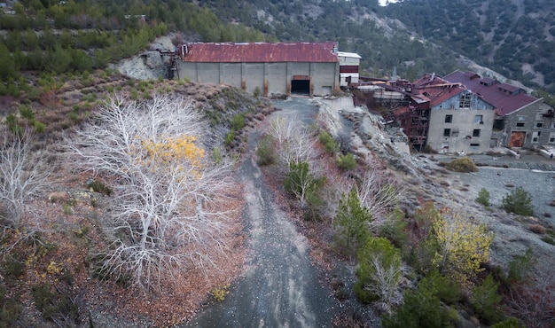 Abandoned factory buildings of asbestos mine and colorful\
autumn landscape of amiantos cyprus