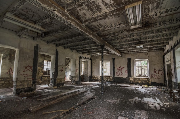 Abandoned hall with painted wooden ceiling