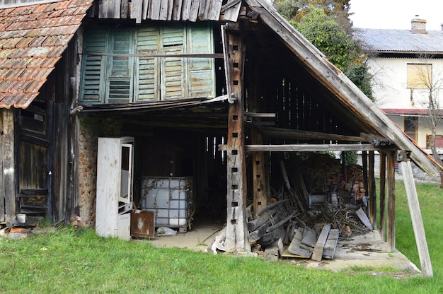 Abandoned house on field against old building