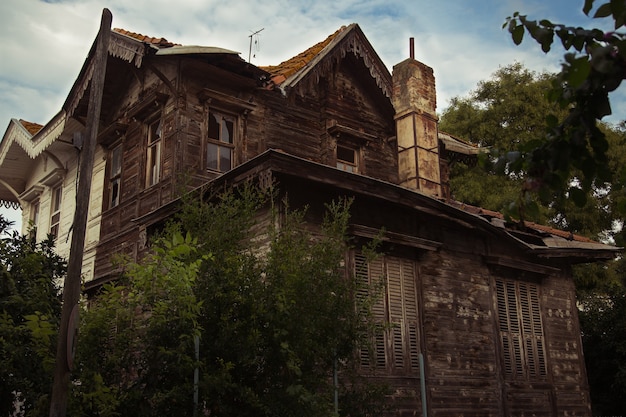 Abandoned house with broken windows in the center of a town.