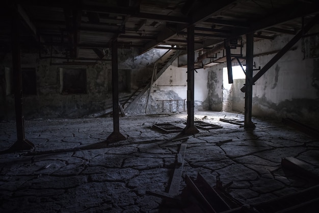 Premium Photo | Abandoned industrial dark room with cracked floor