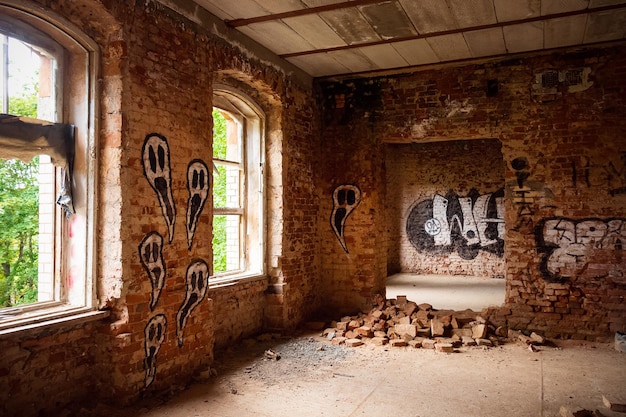 Abandoned old red brick building inside with ghosts painted windows without glasses