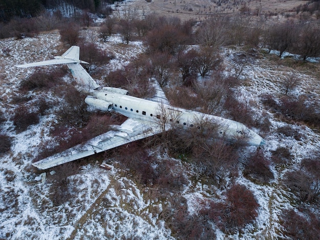 Abandoned passenger plane wreck in the forest in winter