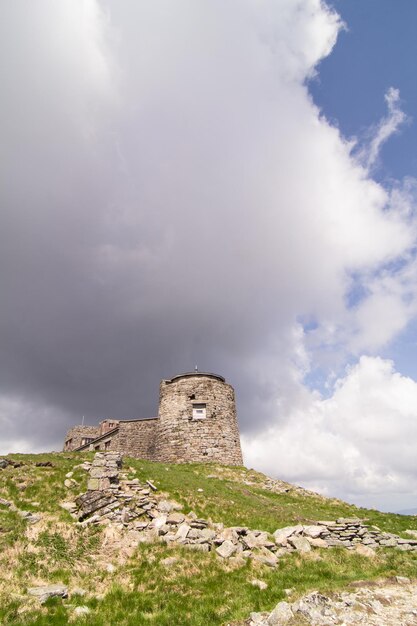 Abandoned stone fortress on cliff landscape photo