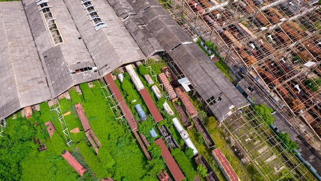 Abandoned train station and wagon with forest covering part of them Aerial view on the city of Sorocaba Brazil