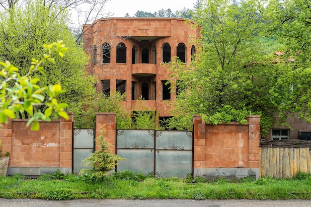 Abandoned unfinished orange stone house in Dilijan Armenia